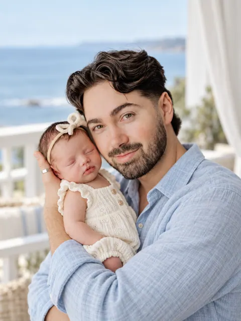 Father and newborn on coastal veranda-6